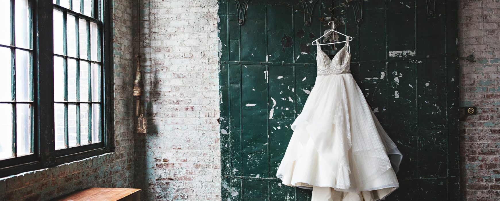 Wedding dress hanging on a sliding barn door
